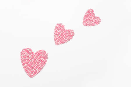 three pink hearts from the pastry decoration on a white background. romantic love background for Valentine's day, birthday, holiday, party, wedding.の写真素材