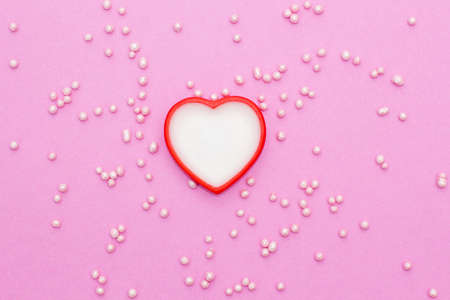 white with a red heart on a pink background with confectionery decoration. romantic love background for Valentine's day, birthday, holiday, party, wedding.の写真素材