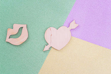 wooden female lips and heart on colorful background. romantic love background for Valentine's day, birthday, holiday, party, wedding. flat lay. Top view.の写真素材