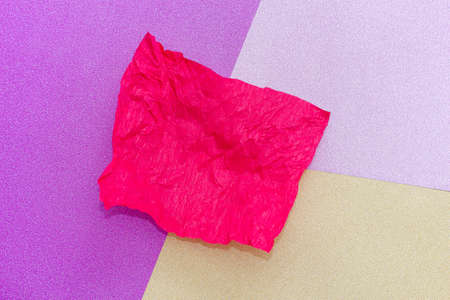 the red sheet of crumpled paper in the background of several colors: yellow, pink, purple with copy space. Texture of fashion, minimal concept, Flat lay, Top view.の写真素材
