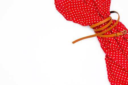 flat lay feminine red dress on white background. fashion minimal concept. Top view.の写真素材