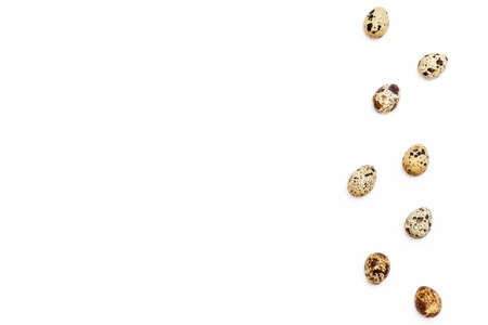 a few Easter quail eggs on the right on a white background. Easter festive background. Top view. Flat lay.の写真素材