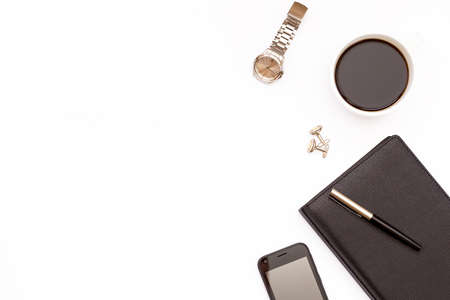Black diary, pen, phone, watch and a Cup of black coffee on a white background. Minimal business concept for men. Flat lay. Top view.の写真素材