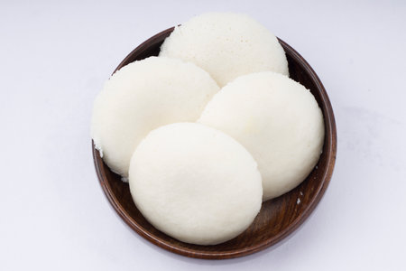 Idly or Idli, south indian main breakfast item which is beautifully arranged in a wooden round bowl...