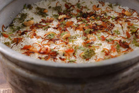 Dum chicken biriyani, close up image of Kerala-Thalassery biriyani garnished with fried onion,cashew...