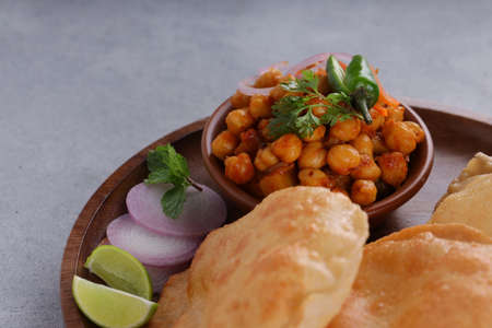 Indian breakfast _Puri with chickpea chana masala curry,tasty indian dish made using all purpose...