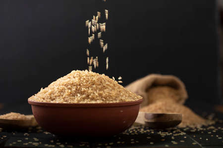 Kerala Matta rice _parboiled rice or palakadan matta or red rice arranged in an earthenware and...
