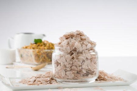 Raw poha or Aval placed with Aval upma or poha  upma or kanda poha upma,healthy indian breakfast item which is very tasty and easy to cook and it is arranged in a wooden bowl with white textured background.,selective focusの写真素材