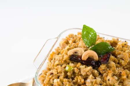 Aval upma or poha  upma or kanda poha upma,healthy indian breakfast item which is very tasty and easy to cook and it is arranged in a wooden bowl with white textured background.の写真素材
