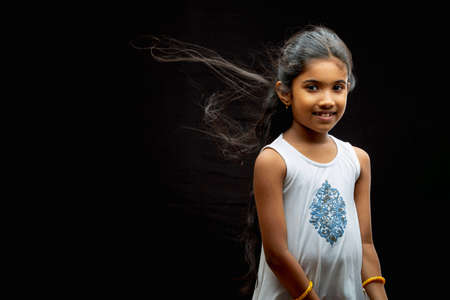 Indian Kid, candid photo of a girl child,isolated on black background