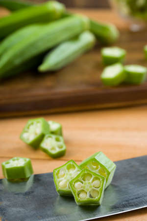 Okra or Lady's finger or Bhindi ,closeup image of fresh green vegetable sliced rings arranged  on ...