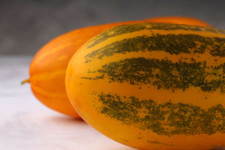 Yellow cucumber or Dosakai ,which is mostly found in south India,It is also known as Kanivellari,a tasty and healthy vegetable,with grey textured background,isolatedの写真素材