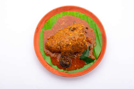 Fish head curry,Rohu fish head curry in south indian style arranged in an earthenware isolated on white background.の写真素材