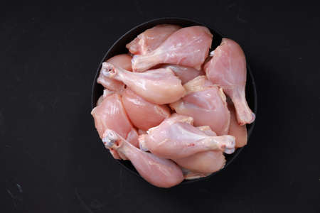 Raw chicken biriyani cut without skin arranged on black container , top view.の写真素材