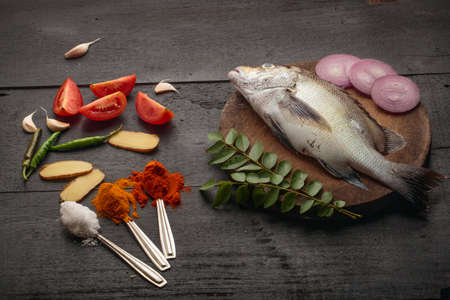 Fresh raw fish and food ingredients, Traditional Kerala style Fish curry cooking