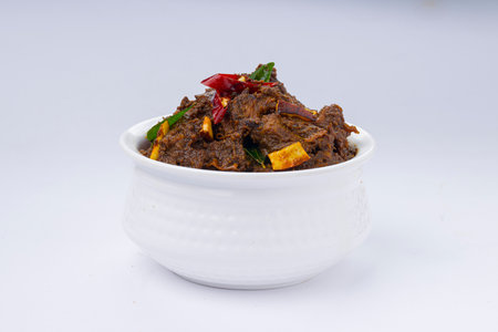 Beef roast masala or curry homemade recipe arranged in white bowl  with white backgroundの写真素材