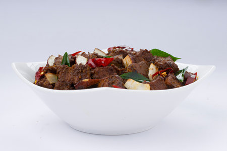 Beef roast masala or curry homemade recipe arranged in white bowl  with white backgroundの写真素材