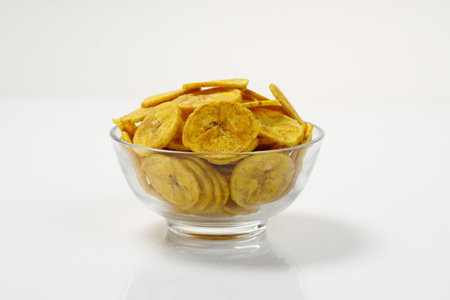 Kerala chips or Banana chips, cult snack item of Kerala,arranged in  atransparent bowl;Isolated image with white backgroundの写真素材