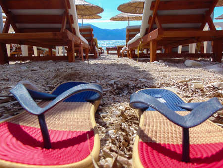 Beach view from a pair of flip-flops.の写真素材