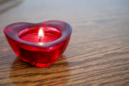 Heart shape with burning candle inside. Valentine Day Concept.の写真素材