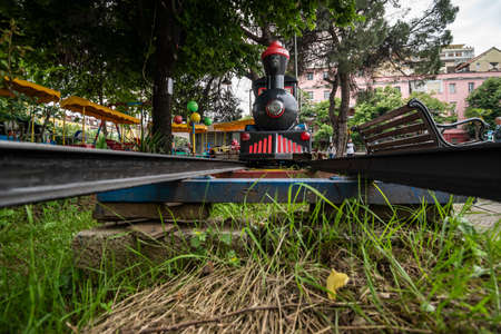 Tirana, Albania - May 2019: Steam train for children in an amusement park in Tirana.のeditorial素材