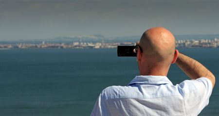 Man taking a picture with a mobile phone. Picture taken in Lisbon / Portugal.の写真素材