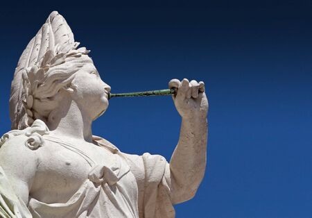 Ancient statue of a trumpeter at the Plaza de Commercio in the historical center of Lizbon / Portogal.の写真素材