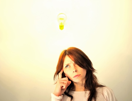 Beautiful young woman with bright idea.の写真素材