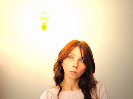 Beautiful young woman with bright idea.の写真素材