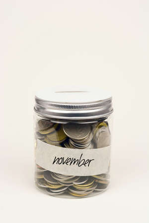 Coins in glass jar for monthly savingの写真素材
