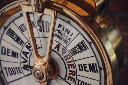 Old fashioned ship engine control throttle lever. Ship engine control throttle lever on the ship`s deck. A ships telegraph on full speed aheadの写真素材
