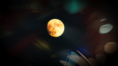 Super full moon at night in the sky with bokeh.の写真素材