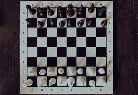 Chess board with figures on it. Black and white photo.