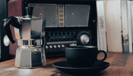 Coffee cup, moka pot and vintage radio on wooden table, stock photoの写真素材
