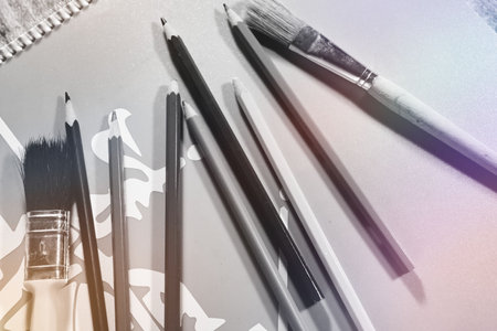 Close up of paintbrushes and pencils on a white background. black and whiteの写真素材