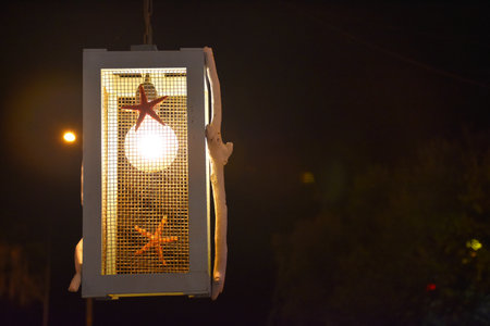 Lantern in the night with a starfish on the street.