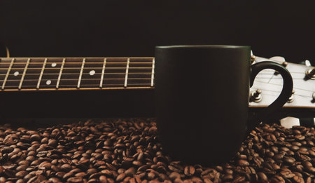 Coffee cup and guitar on coffee beans background, vintage toneの写真素材