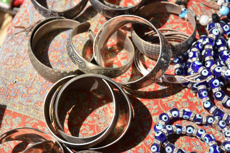 Traditional colorful bracelets with the evil eye for the good luck made from glass and metal in a...