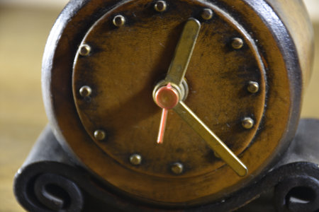 Close up of vintage leather alarm clock. Close-up of alarm clock mechanism, hour and minute hands