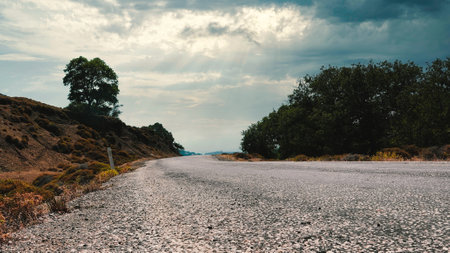 Asphalt road in the mountains under the cloudy sky. Panoramaの写真素材