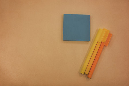 Colorful sticky notes and Pencils on brown paper background. Top view with copy space