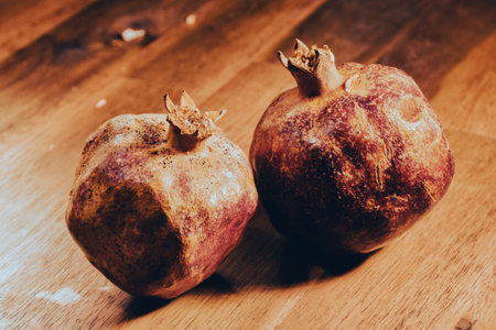 Ripe pomegranate fruit on a wooden background. Vintage style.の写真素材