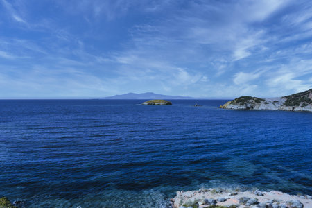 A small islet, cliffs, mountain and bay view in the virgin bays of Ä°zmir FoÃ§a. Virgin coves of the Aegean Sea. Phokaia, Izmir Bays.The view of the Karaburun mountainsの写真素材