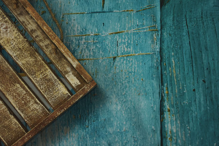 Wooden tray on old blue wooden background, vintage toned.