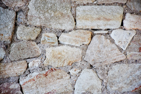 Background of stone wall texture. Close-up. Selective focus.の写真素材