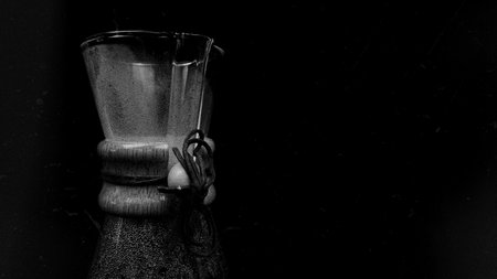 Coffee Brewing Jug on a dark black background. Pour over brewing pour over coffee on a dark background. a jug for pouring over coffee. Manual brewing still life.の写真素材