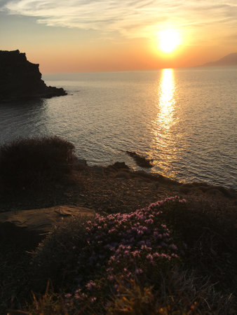 Sunset, waves and volcanic mountain view from Yildizkoy beach on Gokceada Imbros island. Canakkale Turkeyの写真素材