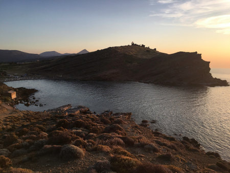 Sunset, waves and volcanic mountain view from Yildizkoy beach on Gokceada Imbros island. Canakkale Turkeyの写真素材