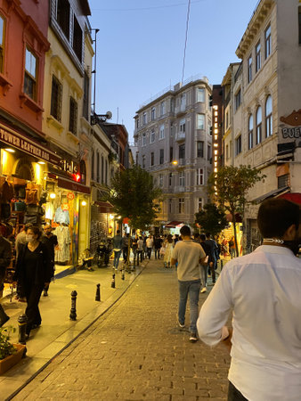 Beyoglu, Istanbul, Turkey April 20, 2023 A view of Galata tower with roaming tourists in narrow streetの写真素材