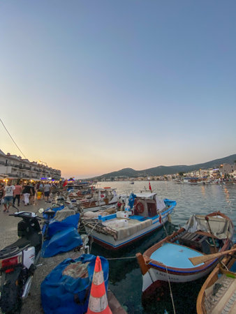 FoÃ§a, Ä°zmir, Turkey 29 Jun 2021 Fishing boats with Turkish flags along the coastline of FoÃ§a holiday resort, daily tour boats, hotels and restaurants on the opposite shore.のeditorial素材
